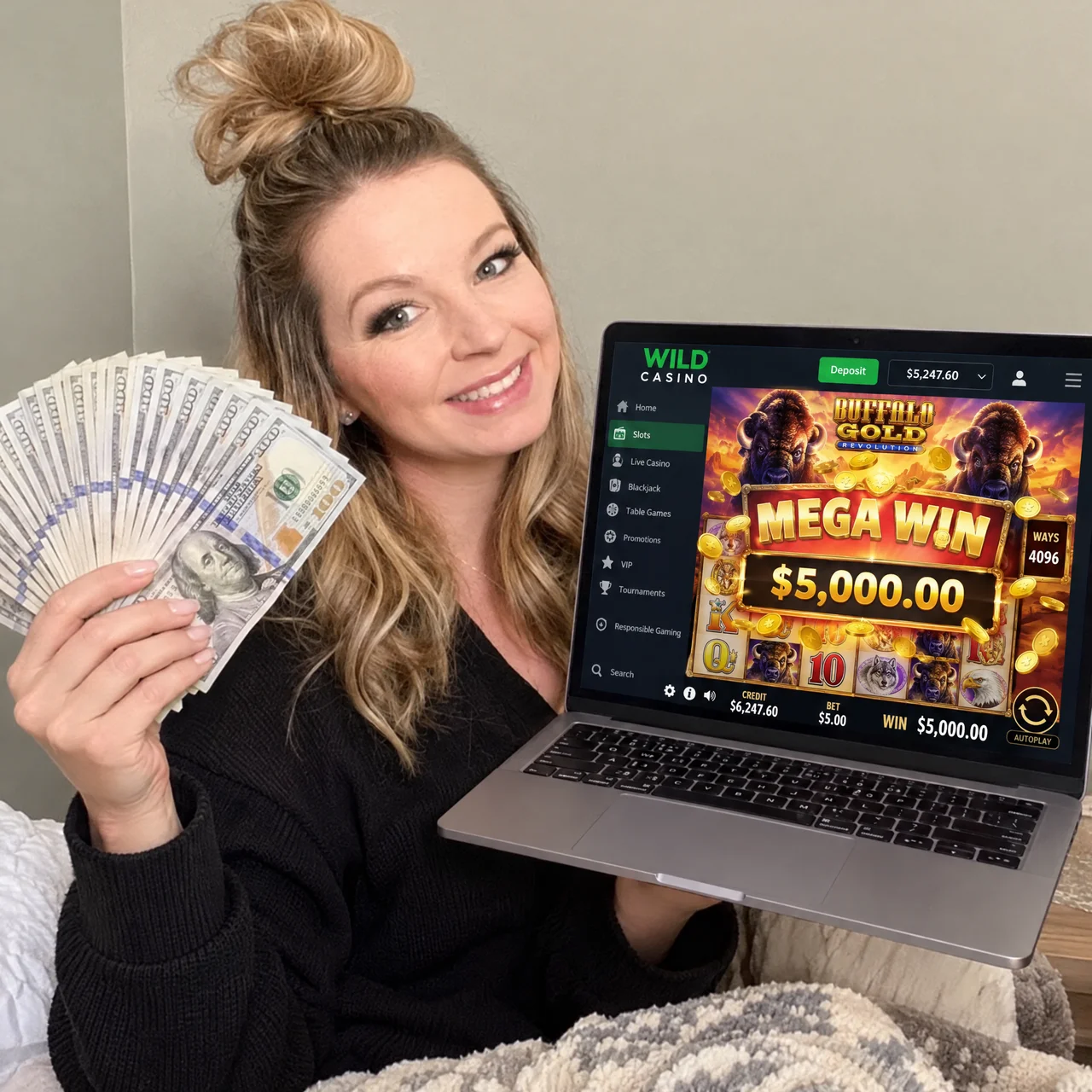 Reader holding her winnings next to a laptop